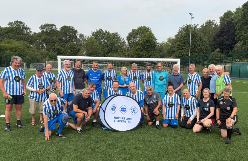Dame Harriett Baldwin MP (centre) pictured with players from Movers and Shakers FC.
