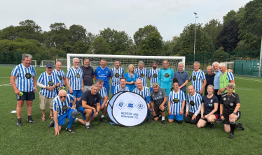 Dame Harriett Baldwin MP (centre) pictured with players from Movers and Shakers FC.